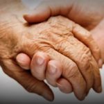 Photo of two hands clasped together